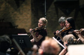 Rachael Beesley leads orchestra seventeen88