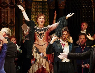 Dominica Matthews as Flora Bervoix, Samuel Dundas as Marquis D’Obigny and the Opera Australia Chorus in Opera Australia's production of La Traviata. Photo credit: Keith Saunders